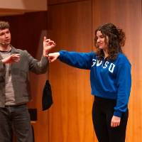 trent james comedian with student holding a bag